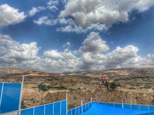 a view of the mountains from a tennis court at Aqua Blue Villa-Dead Sea, Jordan in Amman