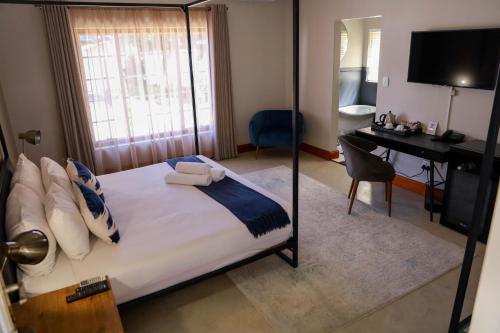 Ένα ή περισσότερα κρεβάτια σε δωμάτιο στο Uitsig Boutique Hotel
