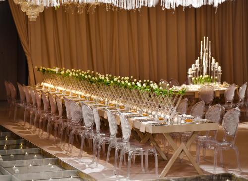 a long table with chairs and flowers on it at Address Istanbul in Istanbul