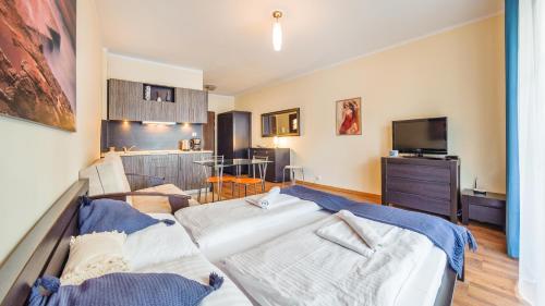 a living room with a couch and a tv at Promenada I, Sun & Snow in Świnoujście