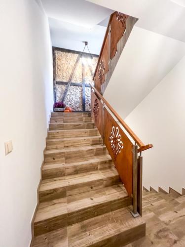 a staircase in a house with white walls and wooden floors at Gościniec Smrekowa Chata in Glinka
