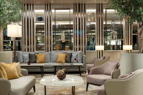 a lobby with couches and chairs and a table at Address Istanbul in Istanbul