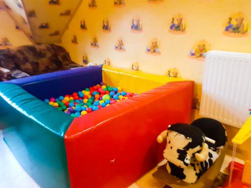 a childs play room with a toy couch and a toy cow at Agroturystyka Pod Złotą Wiechą in Uście Gorlickie