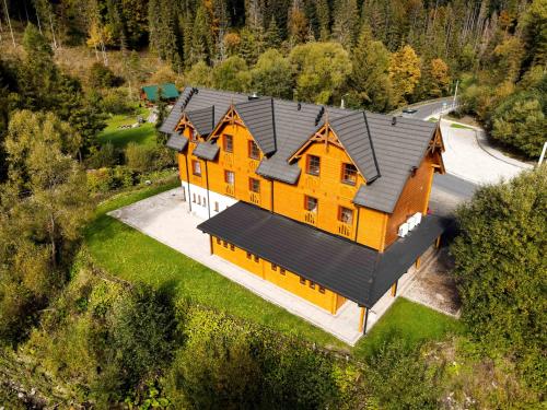 an overhead view of a large house with a black roof at Gościniec Smrekowa Chata in Glinka