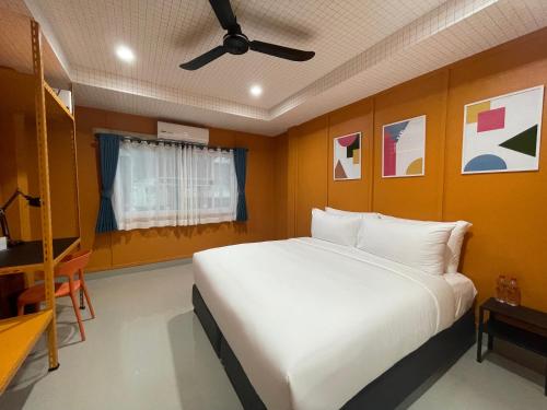 a bedroom with a large bed and a ceiling fan at Sari Boutique hotel in Patong Beach