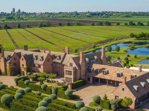 an aerial view of a large house with a lake at The Old Hall Ely in Ely