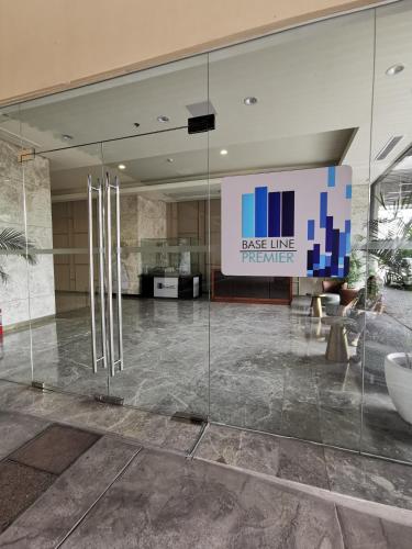 a lobby with a large glass wall in a building at Baseline Premier - Studio with mountain view in Cebu City