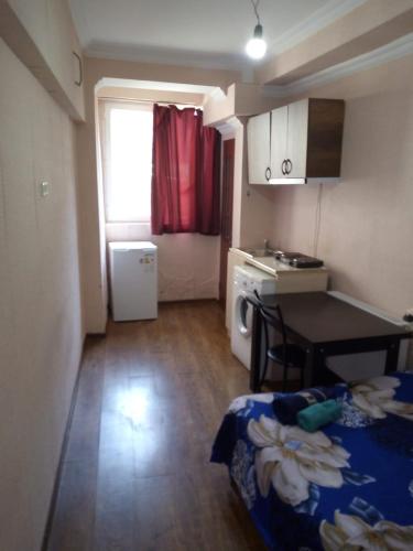 a small room with a kitchen with a table and a kitchen at vake-house in Tbilisi City