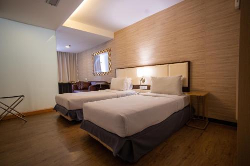 Ένα ή περισσότερα κρεβάτια σε δωμάτιο στο Citrus Hotel Johor Bahru by Compass Hospitality