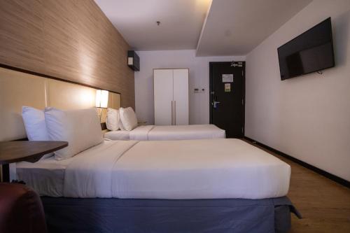 Ένα ή περισσότερα κρεβάτια σε δωμάτιο στο Citrus Hotel Johor Bahru by Compass Hospitality