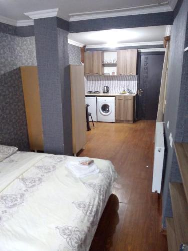 a small room with a bed and a kitchen at vake-house in Tbilisi City