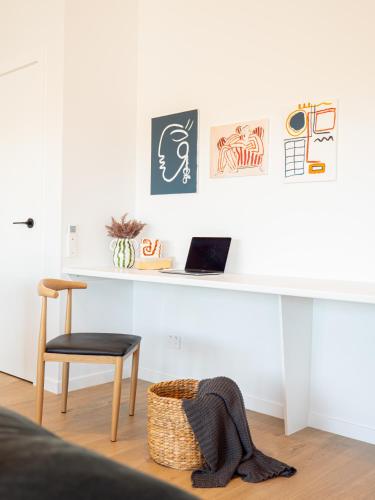 a white desk with a chair and a laptop on it at Luxurious Waterfront home in the North of Hobart in Hobart