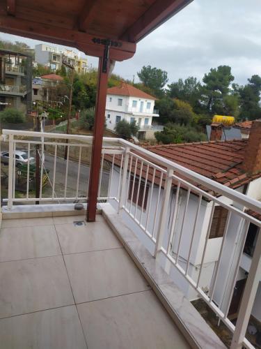 a balcony with white railing on a house at SMILE in Platamonas