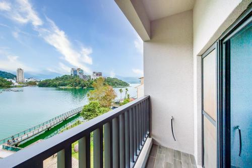 a balcony with a view of a body of water at Sun Moon Lake I Love You in Yuchi