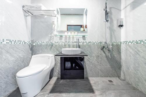 a bathroom with a toilet and a sink and a mirror at Sun Moon Lake I Love You in Yuchi