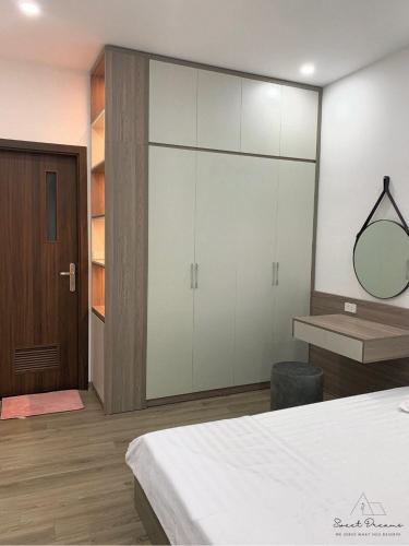 a bedroom with a large closet with a mirror at Sweet Dreams Homestay Westlake Hanoi in Hanoi