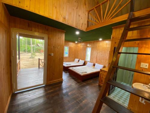 a large room with a bed and a living room at Bungalow - Homestay LÀNG BÈ in Ben Tre