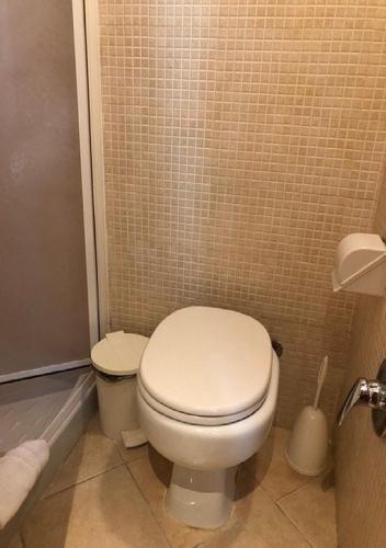 a bathroom with a white toilet in a tiled room at Hotel Labelle in Rome