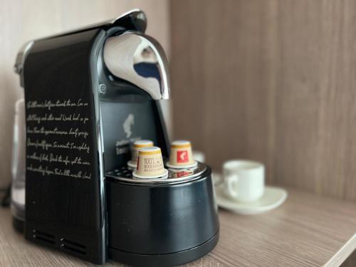 a coffee maker sitting on a table next to a cup at Novotel World Trade Centre Dubai in Dubai