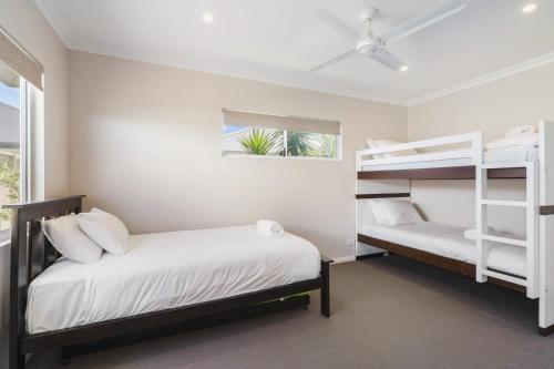 a bedroom with two bunk beds and a window at AZZURE on WATERVILLE in Dunsborough