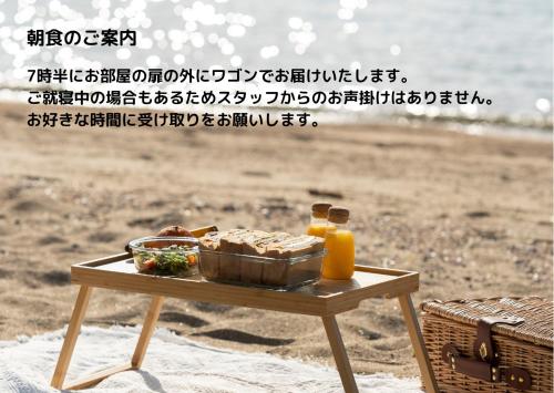 a tray of food on a table on the beach at SETOUCHI SUP RESORT - Ao - in Shodoshima