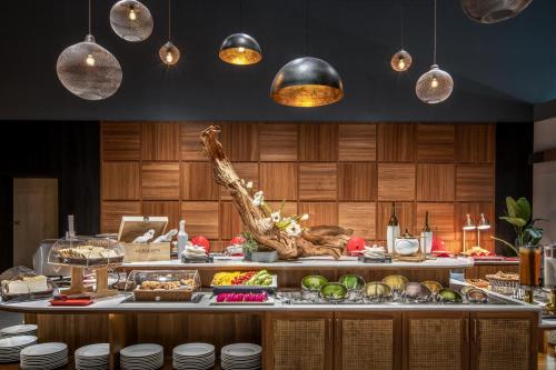 a buffet with food on a table with pendant lights at River Inn Kenting in Hengchun