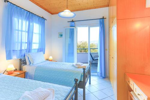 a bedroom with two beds and a window at Theophilos Dio in Ágios Stéfanos