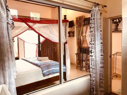 a bedroom with a window with a bed in it at Thomas' Retreat Bukit Lawang in Bukit Lawang