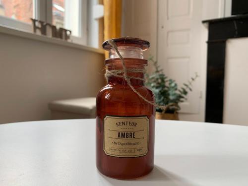 a bottle of sauce sitting on a table at Florimond cosy apparts in Saint-Quentin