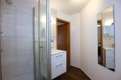 a bathroom with a shower and a sink and a mirror at Haus Gerlinde in Zell am Harmersbach