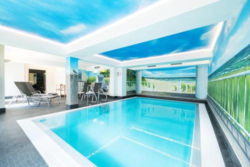 a swimming pool in the middle of a house at AKZENT Apartmenthotel Binz in Binz