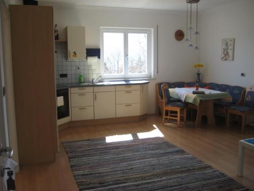 uma cozinha e sala de jantar com uma mesa e uma janela em Haus Gilli em Lagundo