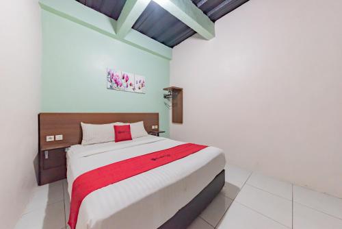 a bedroom with a large bed in a room at RedDoorz near UNSIKA University Karawang in Karawang