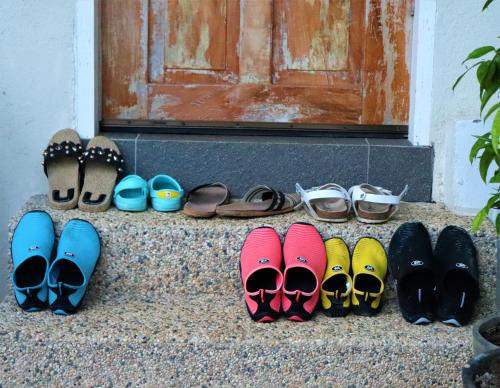 a group of pairs of shoes sitting on a step at Island View Beachfront Resort in Anda