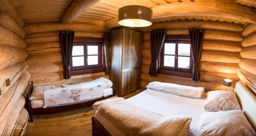 a room with two beds in a log cabin at Zrub pod Poľanou in Detvianska Huta