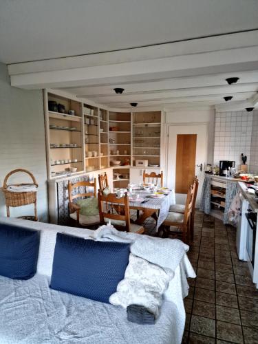 a room with two beds and a table and a kitchen at Haus Dany in Raeren