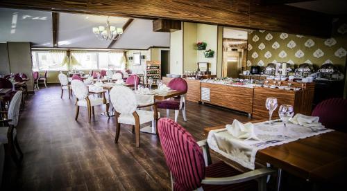 a dining room with tables and chairs in a restaurant at Koza Suite Hotel in Ankara