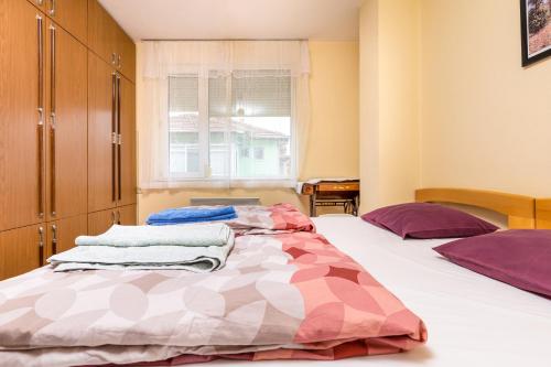 a bedroom with two beds and a window at Quiet apartment near the center in Plovdiv