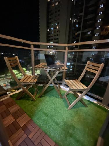a pair of chairs and a table on a balcony at Le 10 The Radiance Manila Bay in Manila
