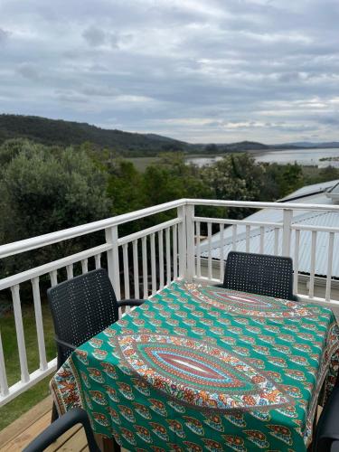 a table and two chairs on a balcony with a tableablish at Beside Still Waters in Wilderness