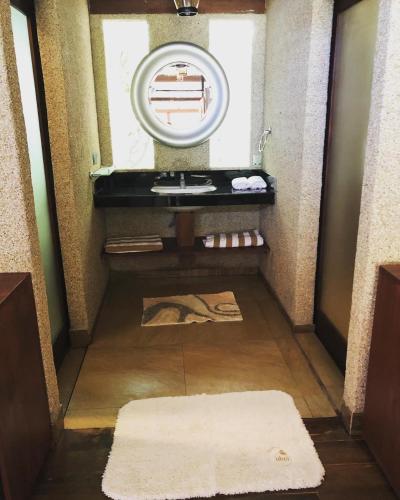 a bathroom with a sink and a mirror at OHEI in Tangalle