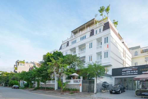 a white building on the side of a street at M Village Living Nguyễn Văn Hưởng in Ho Chi Minh City