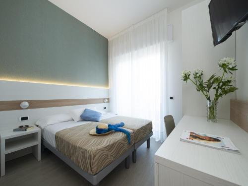 Ένα ή περισσότερα κρεβάτια σε δωμάτιο στο Hotel Pillon