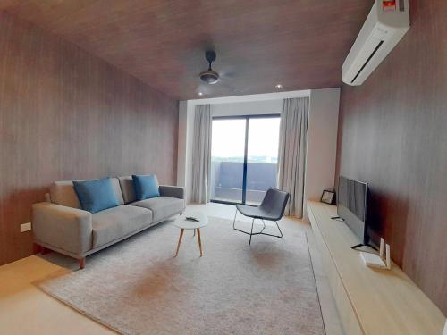 a living room with a couch and a tv at Lumi Tropicana in Petaling Jaya