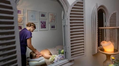 a man and a woman in a room with a mirror at Frost Boutique Hotel in Pärnu
