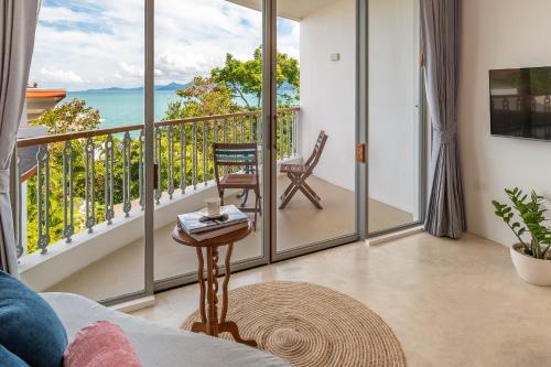 a living room with a view of the ocean at Ampersand Resort in Bophut 