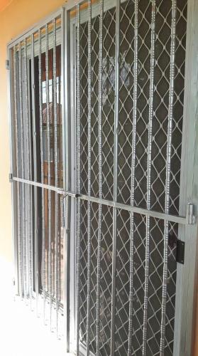 a metal door with bars on a window at Stargazers Apartment in Olongapo
