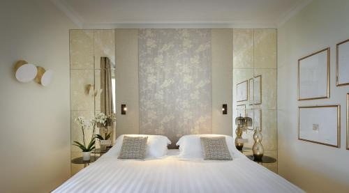 a bedroom with a large white bed with two pillows at Villa Marina Capri in Capri