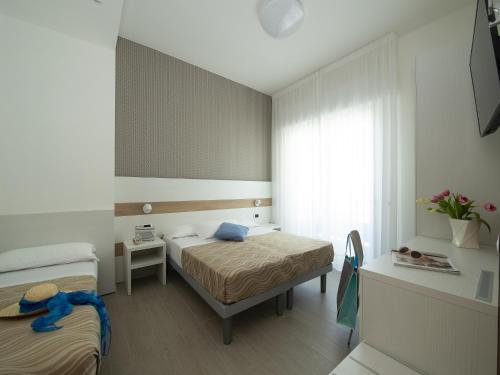 Ένα ή περισσότερα κρεβάτια σε δωμάτιο στο Hotel Pillon