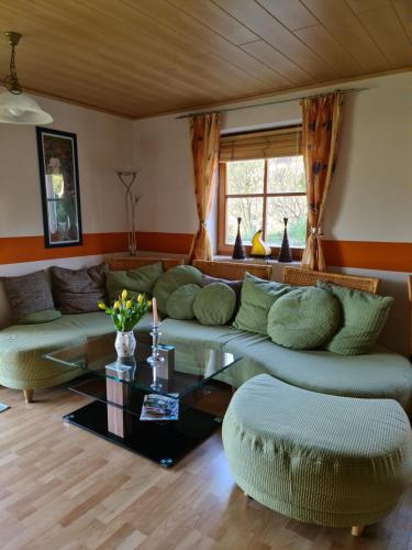 a living room with a couch and a table at Ferienwohnung HOAMAT Schmalzreich Andrea in Lam